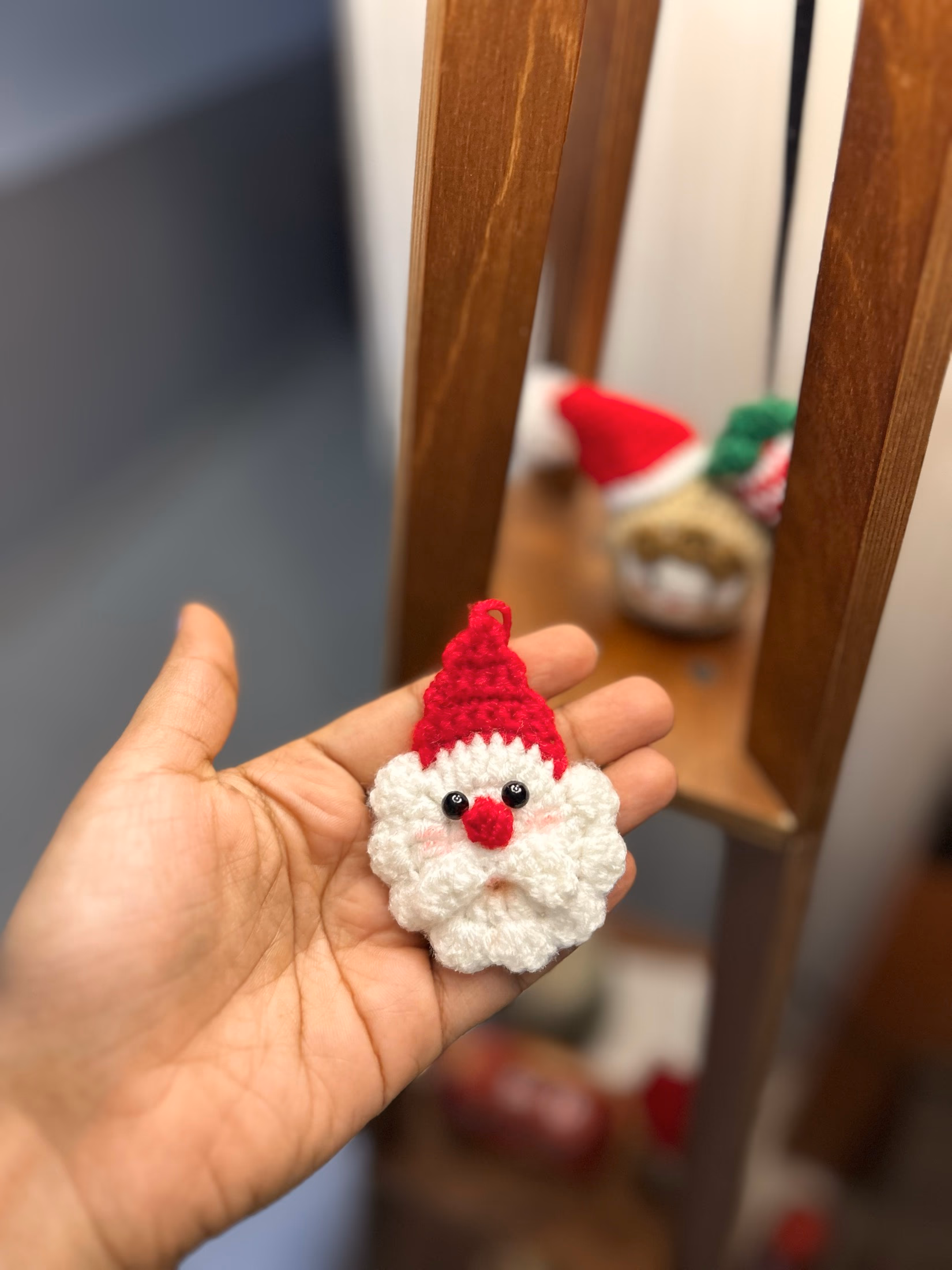 Crochet Santa ornament held in one hand